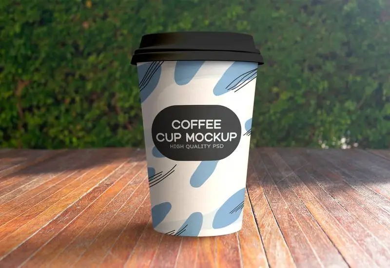 Mockup of Paper Coffee Cup in Outdoor Scene