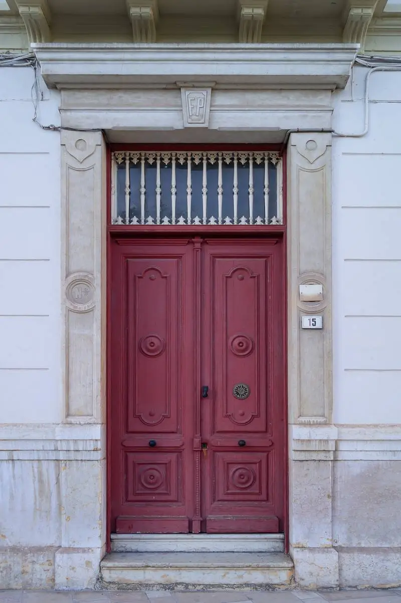 Photo of Antique Red Wooden Door in a Classic Building