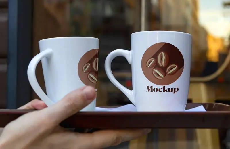 Mockup of Two White Mugs on a Tray in an Outdoor Scene