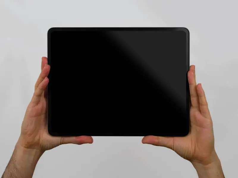 Black Tablet Pro Screen Horizontally Held by Two Hands
