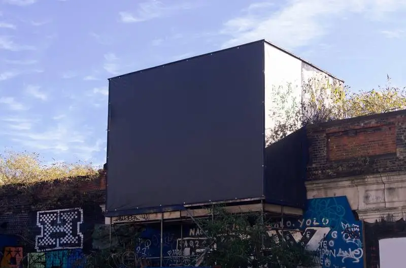 Photo of a Dark Large Format Canvas on a Building