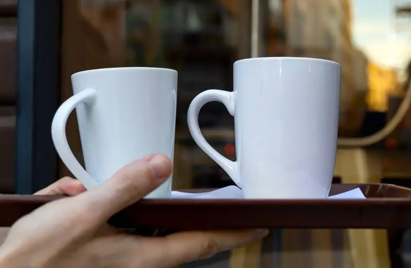 Photo of Two White Hardcover Books in an Exterior Scene
