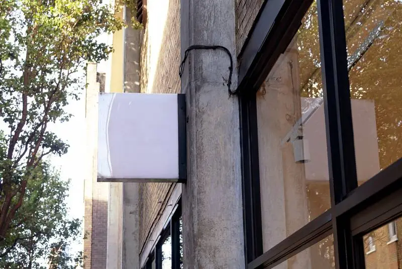 Photo of White Posters on a Wall of Glass Panels