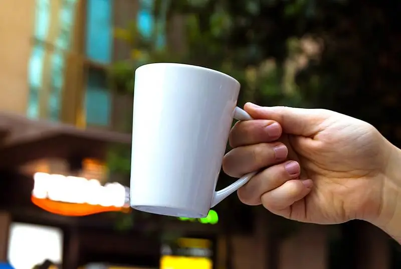 White Coffee Cup Design in Outdoor Scene