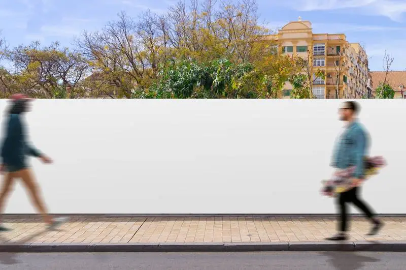 Canvas Fence in a Street with People Walking