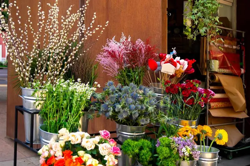 Photo of Vases with Coloured Flowers in the Street