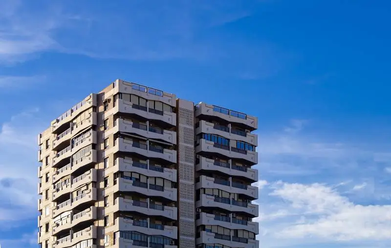 Photo of Modern Building on Blue Background with Clouds