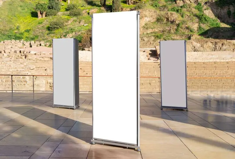 Photo of Collection of White Panels in Street with Classical Building in Background