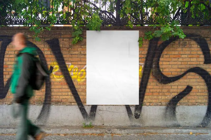 Photo of a Blank Poster Pasted on a Brick Wall