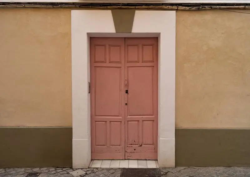 Photo of an Old Pink Wooden Door in an Old Building