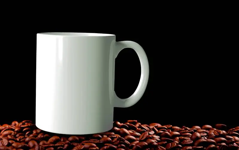 Image of Cup on Mountain of Coffee Beans on Black Background