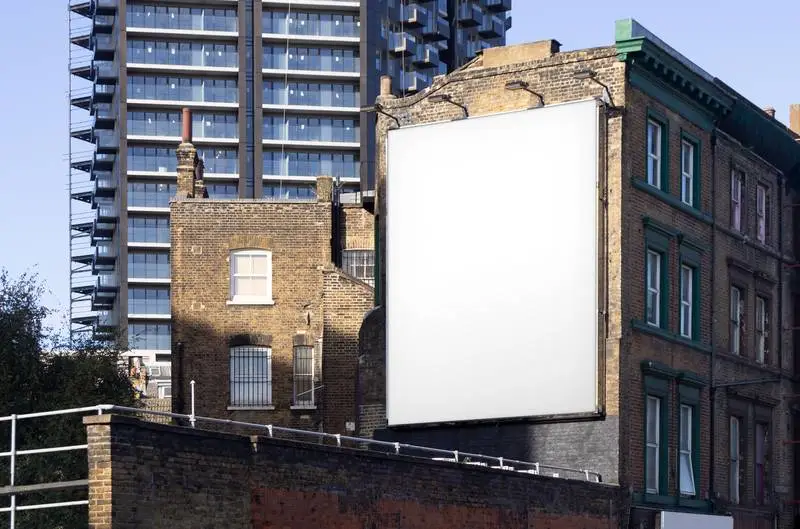 Large Format White Poster on a Building Façade in Modern City