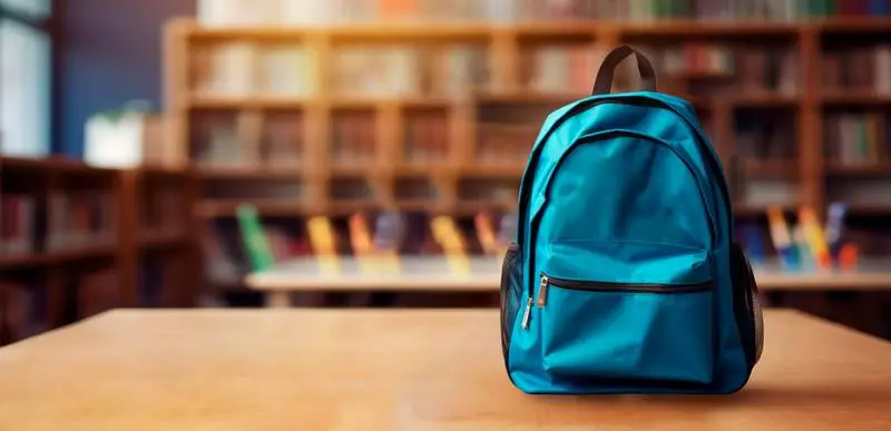 Blank Banner of a Blue Backpack on a Blurred Library Background