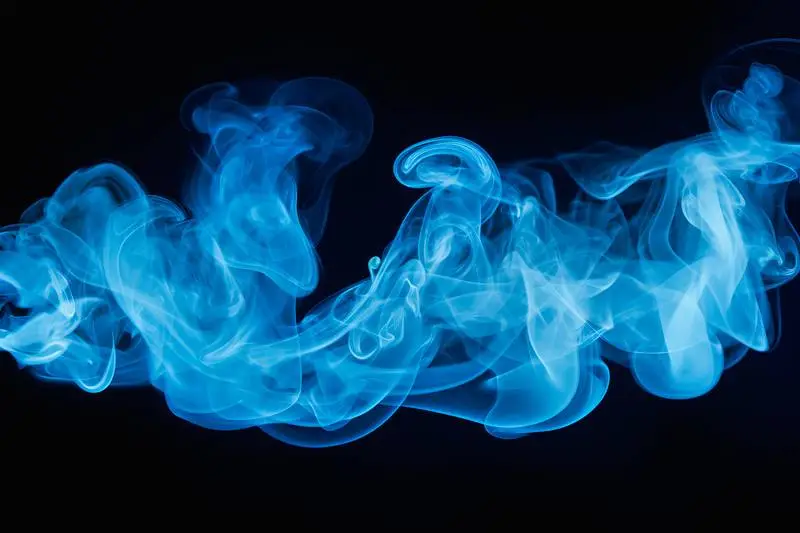 Texture of Blue Smoke Waving on a Black Background