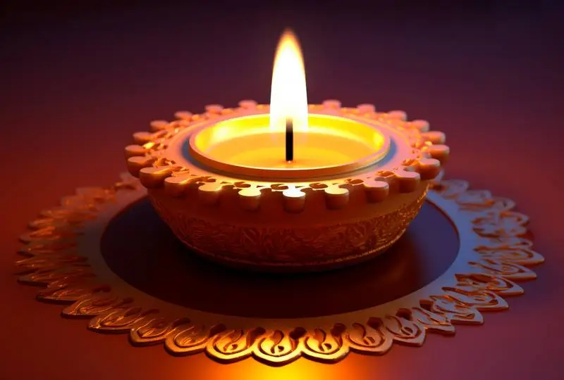 Image of a Realistic Golden Candle for Diwali on a Gradient Background