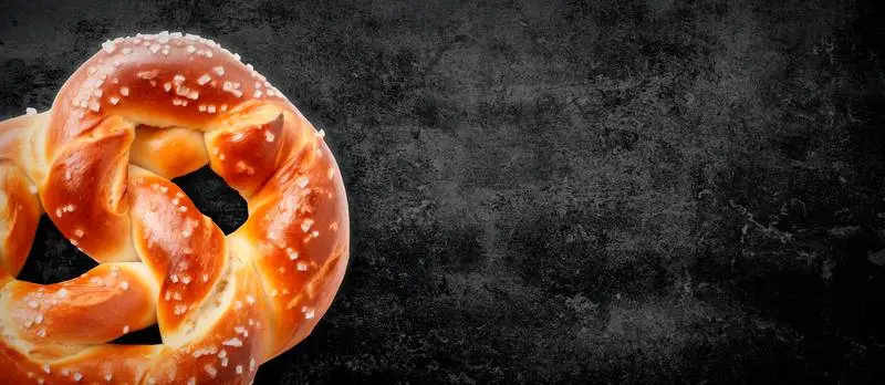 Blank Banner for Oktoberfest Grunge with a Pretzel on a Blackboard Background