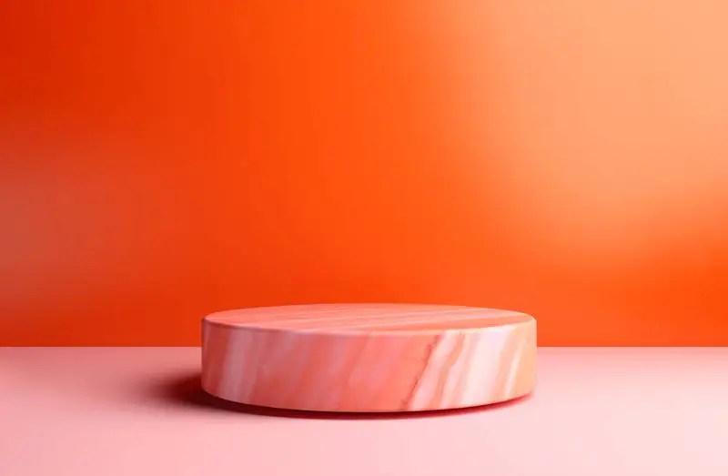 Round Pink Marble Podium on an Orange Plain Background