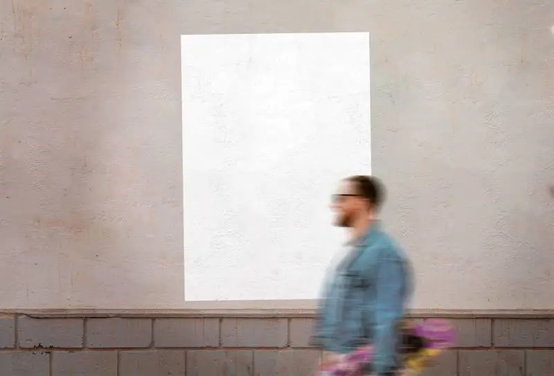 Glued White Blank Poster Over Wall with Pedestrian