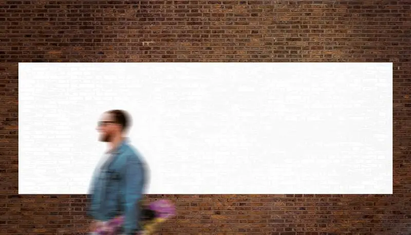 Glued White Blank Large Poster Over Brick Wall with Pedestrian