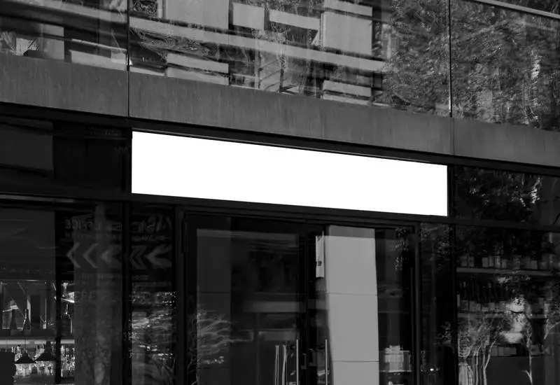 Street Sign on Black and White Glass Building