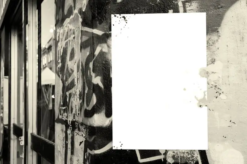Poster on Wall with Black and White Graffiti