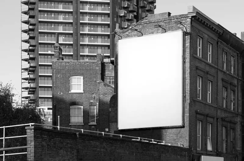 Long Poster on Black and White Brick Building