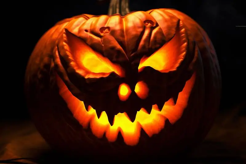 Lantern Halloween Pumpkin with Evil Face on Black Background