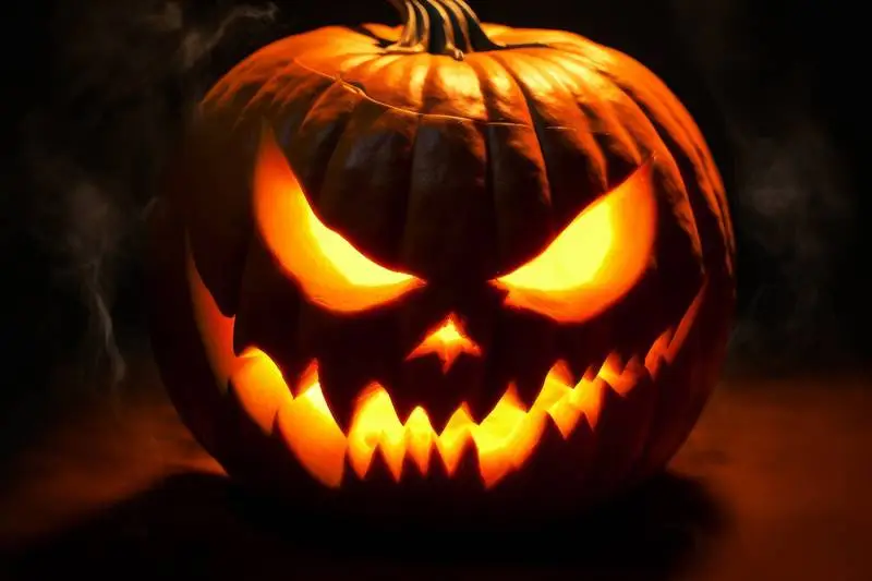 Lantern Halloween Pumpkin with Evil Look on Black Background