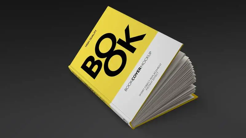 Mockup of a Half-Open Book Lying on a Dark Background