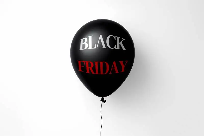 Black Balloon Floating on White Background with Black Friday Message