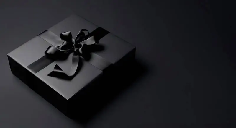 Elegant Image of Black Gift Box With Ribbon on a Dark Background