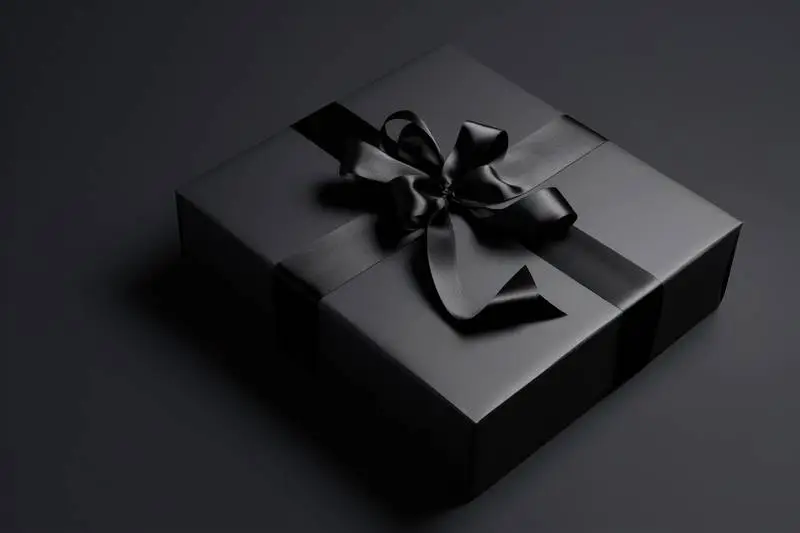 Image of Black Box With Black Ribbon on Dark Background