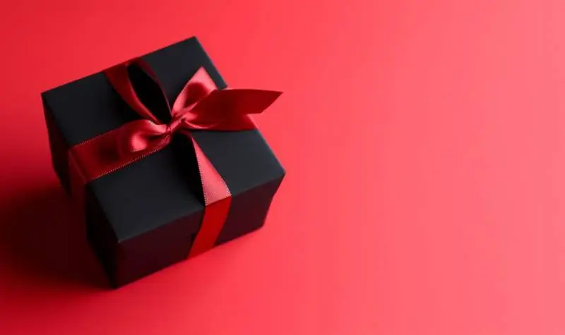 Image of Black Box With Red Ribbon on Red Background