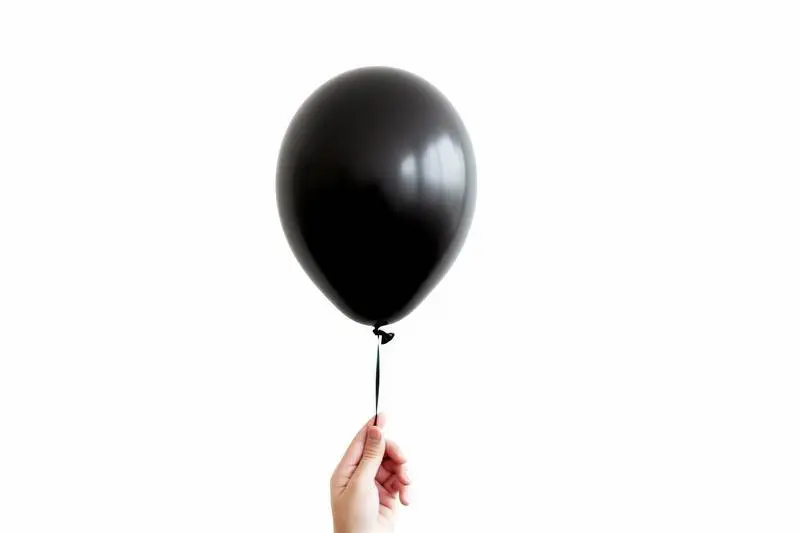 Image of Hand Holding Black Balloon on White Background