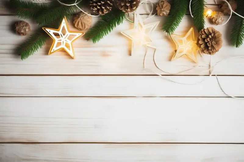 Christmas Image With Garland of Lights and Stars on a White Wooden Background