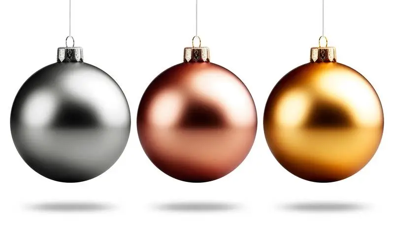 Three Metallic Christmas Balls Hanging Isolated on a Total White Background