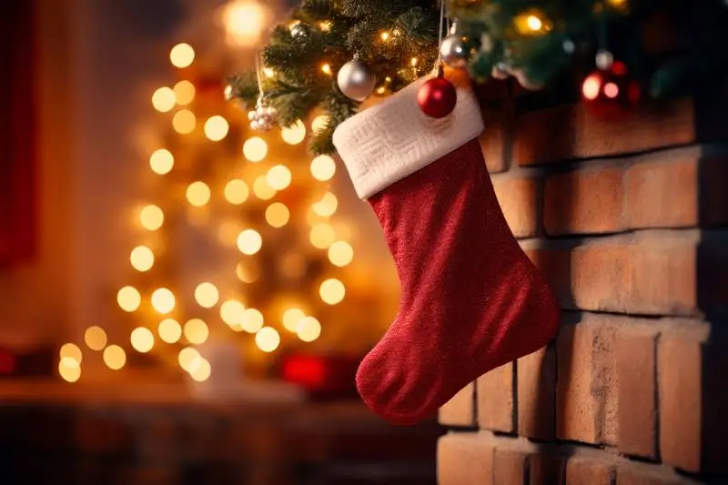 Realistic Image of a Sock Hanging on a Fireplace in a Room With Christmas Decorations