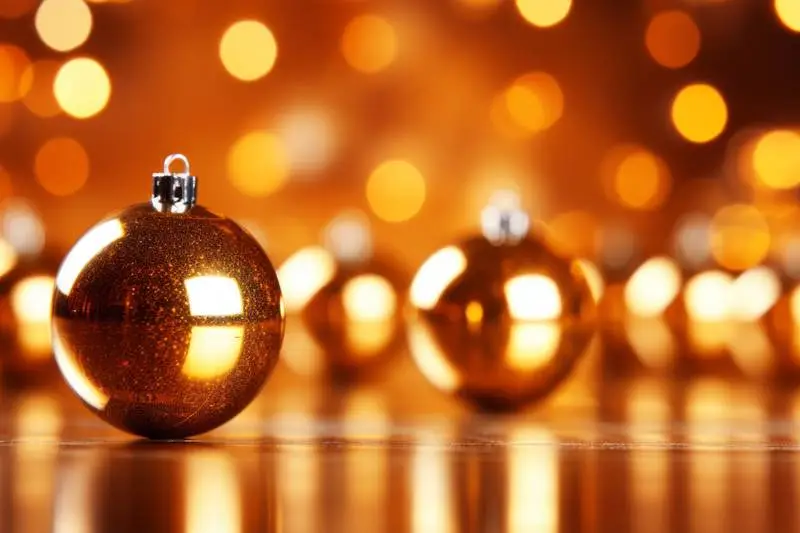 Compositional Image of Golden Balls and Reflection on a Background With Blurred Lights