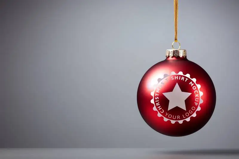 Mockup of Logo on Red Christmas Ball Hung With Gold Rope on Grey Background