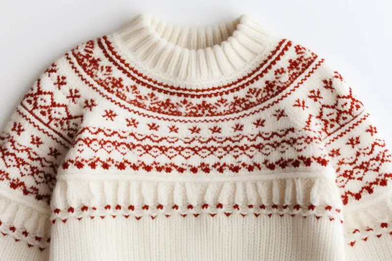 Close-Up Photo of a Red and White Christmas Jumper