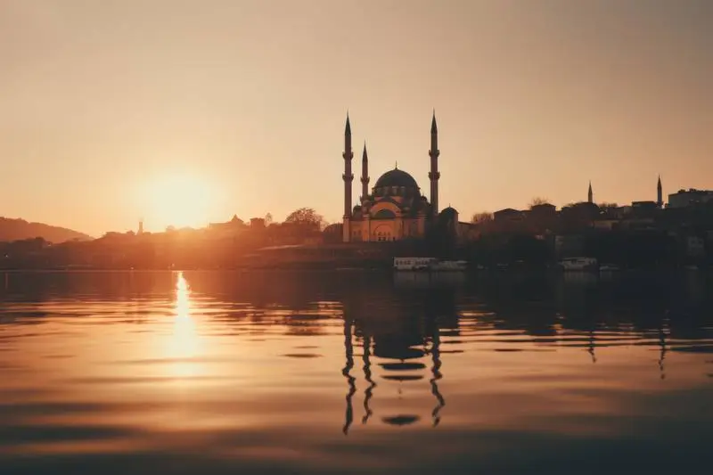 Photo of Mosque with Sunrise over a River