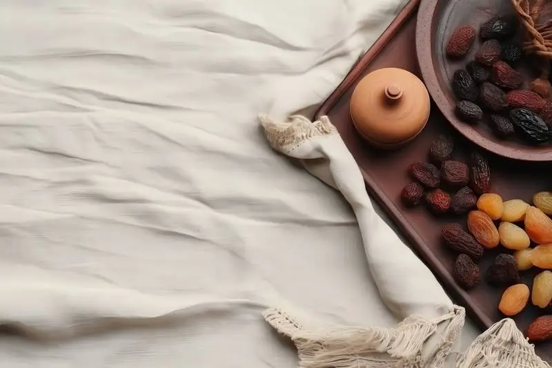 Photo of a Composition of Dates on a Plate on a Wooden Tray with a White Tablecloth