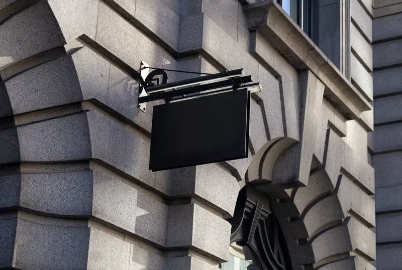 Black Street Sign on Classic Stone Façade