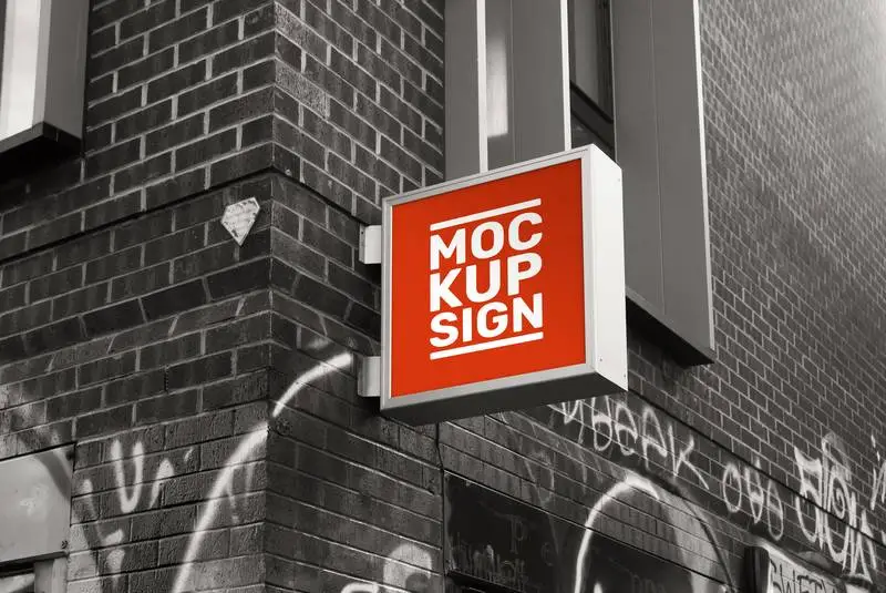 Mockup of Square Street Sign on Black and White Brick Building