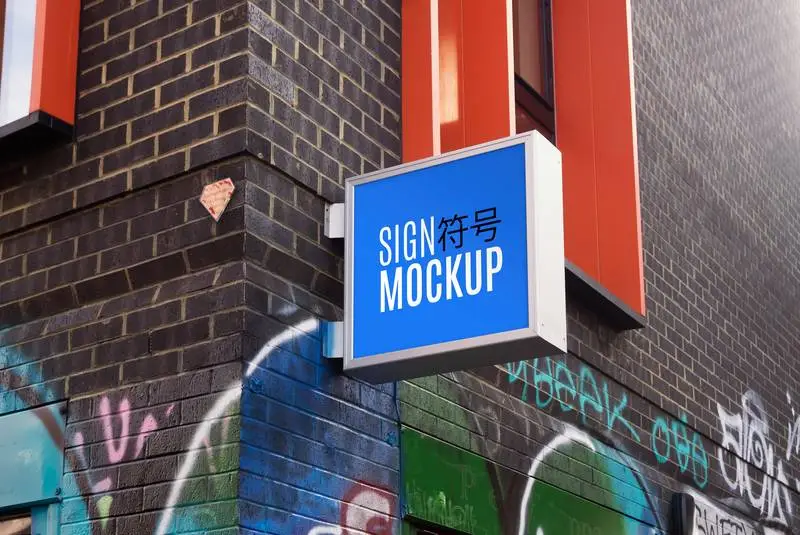 Mockup of Sign on Modern Brick Building and Graffiti Wall