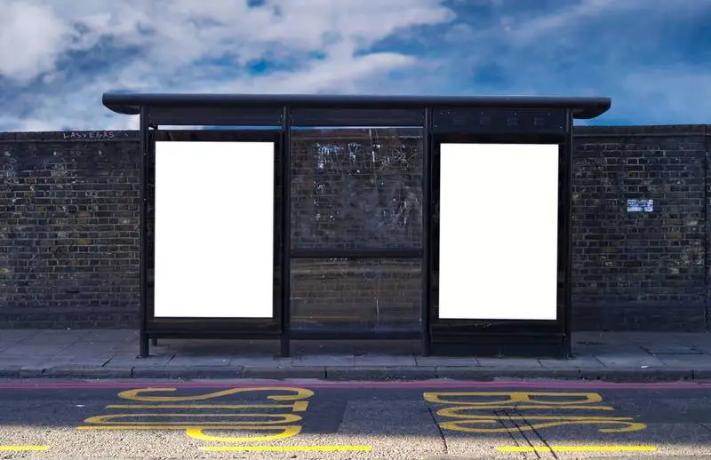 Photo of Two Posters at a Bus Stop