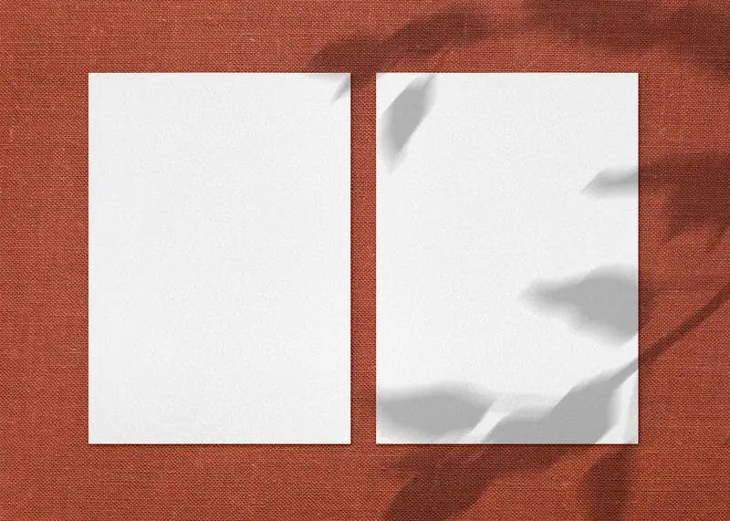 Two Paper Sheets on Fabric Surface Mockup Photo