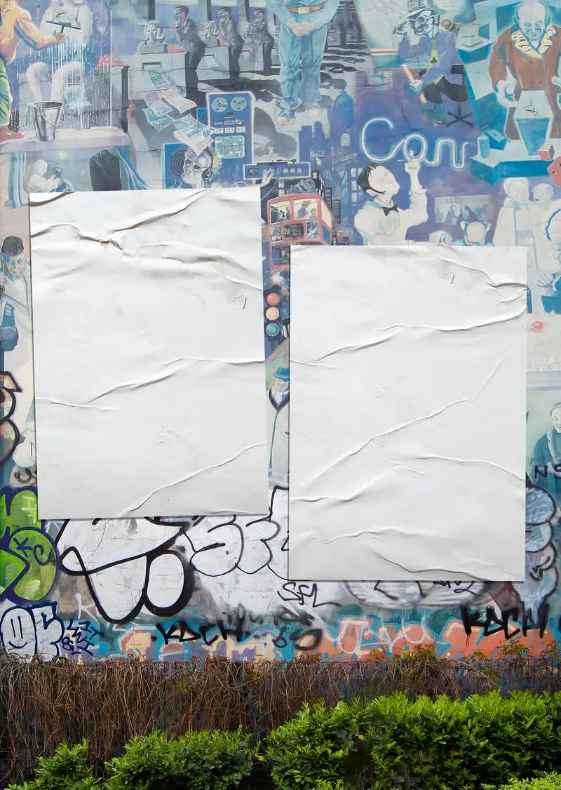 Pack of Crumpled Posters on a Graffiti Wall Background Photo