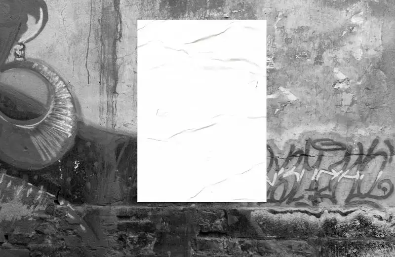 Poster on Wall with Black and White Graffiti Photo