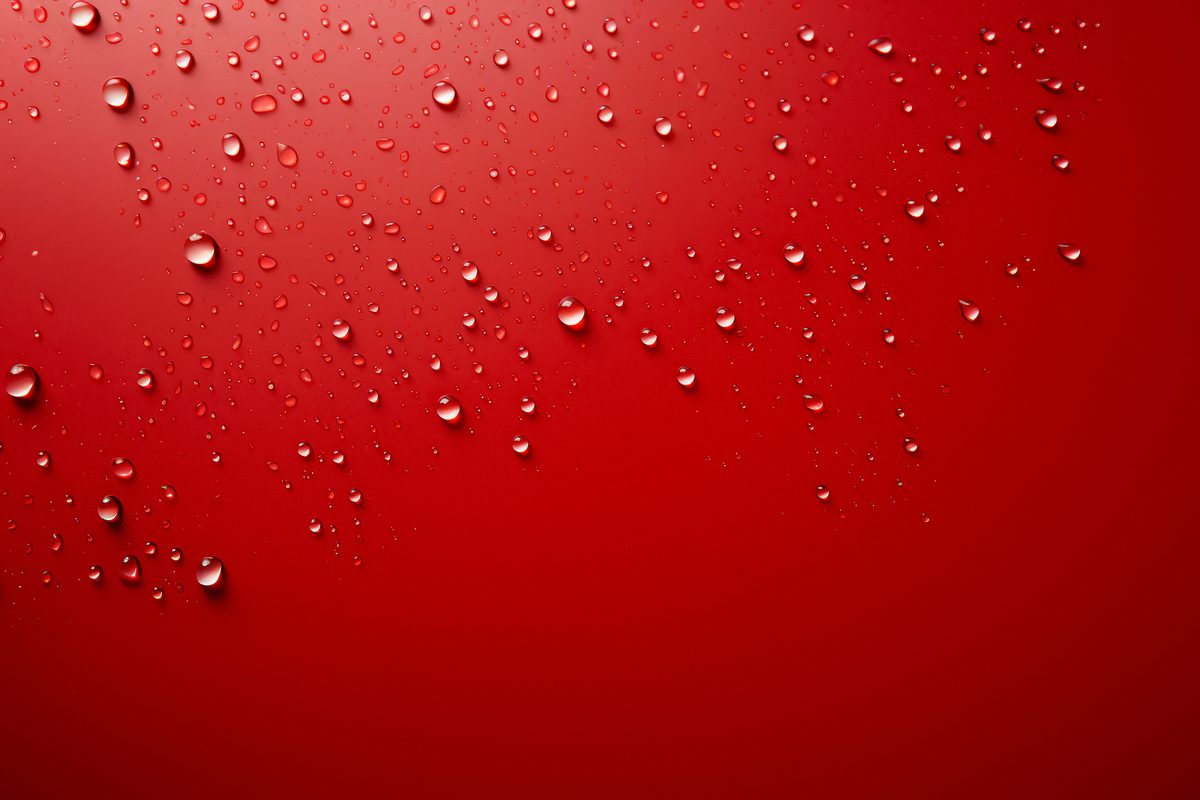 Background of raindrops splashed on a light blue surface